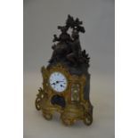 A French garniture clock profusely decorated with courting couple, white dial with twin train