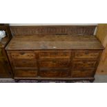 A 17th century and later oak dresser base, the nine crossbanded drawers with brass swan neck handles