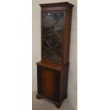 An Edwardian mahogany bookcase cabinet with astragal glazed door enclosing three shelves over a
