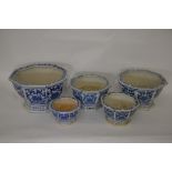 A set of five graduated blue and white octagonal sided jardinieres with pierced feet (5)