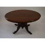 A Victorian mahogany breakfast table, the oval tilt top raised on reeded baluster column and quad