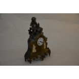 A French reproduction spelter mantle clock with music playing putti, twin train movement, 43 cm