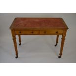 A late Victorian hall table with two drawers, turned and fluted supports with brass castors, 76 cm