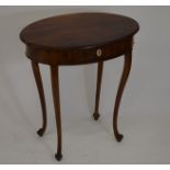 A Victorian mahogany oval side table with single drawer, raised on cabriole supports with scroll