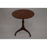 A small round mahogany tilt-top table on shaped tripod base, 60 cm diam, 68 cm high