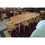 An Ercol elm and beech dining table extending to 220 cm, to/w four Ercol chairs