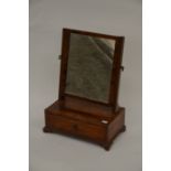 An Edwardian toilet mirror of diminutive proportions, the rectangular swing mirror above a single