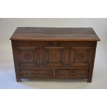 An 18th century carved and panelled oak mule chest with hinged top and two drawers, 122 cm wide x 53