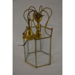 A brass octagonal hanging lantern with bevelled glass panels
