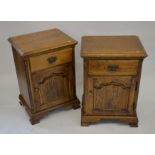 A pair of oak bedside cabinets each with a single drawer over a panelled cupboard, raised on bracket