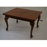 A mahogany extending dining table, the rectangular top with two central leaves raised on cabriole