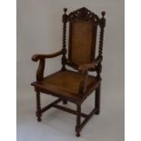 A carved mahogany open armchair with barley twist