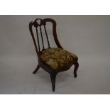 A Victorian rosewood nursing chair, splayed back with spiral turned spindles and tapestry seat