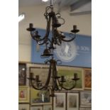 A pair of Italian wrought metal five branch chandeliers