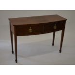 A 19th century mahogany bowfront cabinet with two drawers with brass handles raised on tapering