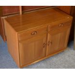 A mid century Ercol elm side cabinet with two drawers over panelled cupboard doors on castors 91