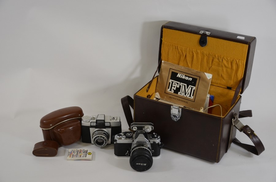 Two SLR cameras, including Nikon, camera case with accessories, telephoto lens etc