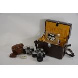 Two SLR cameras, including Nikon, camera case with accessories, telephoto lens etc