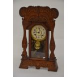 An American oak cased wall clock with carved decoration in the Arts and Crafts style, New Haven