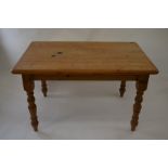 A scrubbed pine kitchen table on turned supports, 89 cm x 134 cm long x 78 cm