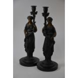 A pair of bronzed candlesticks