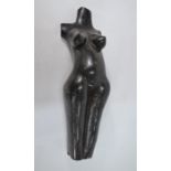 A polished stone sculpture - a female torso