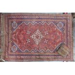 An old Persian Shiraz rug and an old carpet cushion (2)