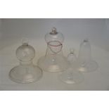 Two pairs of graduated bell-shaped glass cloches with loop tops