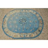 An antique Chinese blue ground oval rug