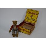 An antique brown plush clockwork somersaulting teddy-bear