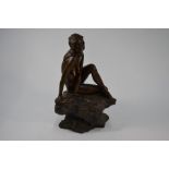 A resin bronze sculpture of a naked siren