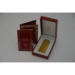 Must de Cartier - A gilt metal cigarette lighter