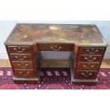 A Victorian mahogany pedestal desk with inverted breakfront top