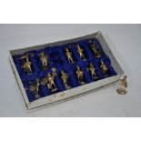 Set of twelve Chinese Sterling figural placecard holders