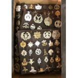 A large collection of British military cap badges and insignia, approx. 200