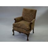 A Georgian style moulded walnut framed upholstered armchair
