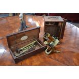 An early 19th century brass surveyor's level and a brass compound microscope