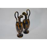 A pair of stoneware ewers of slender form