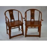 A pair of Chinese elm horseshoe chairs
