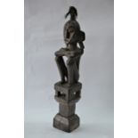 A West African carved wood seated figure