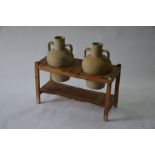 An antique pine jar stand with a companion pair of twin handle earthenware jars