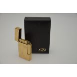 S J Dupont - A cased gilt metal ribbed cigarette lighter