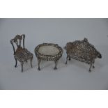 A miniature silver settee, chair and table