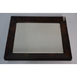 An antique oyster veneered bevel edged mirror plate