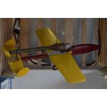A painted wood model aeroplane with rocket engine