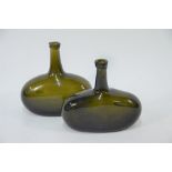 A pair of antique olive-green glass bottles