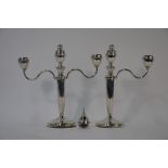 A pair of silver twin branch candelabra