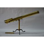 A 19th century large brass astral telescope on folding tripod