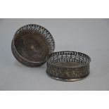 A pair of George III silver bottle coasters