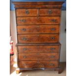 A reproduction George II crossbanded walnut chest on chest